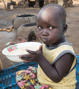 Baby in Africa eats Emergency Food Rations