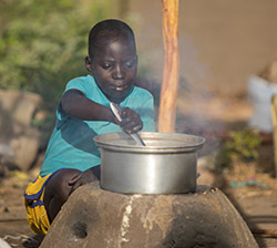 Girl in Africa cooks food