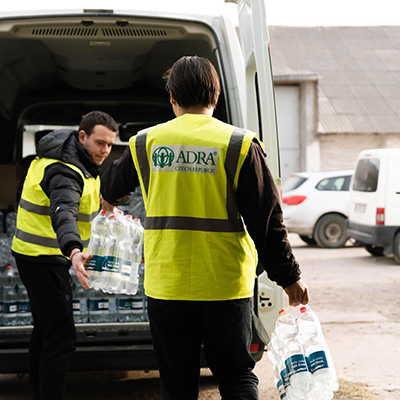 ADRA Volunteers Unload Water